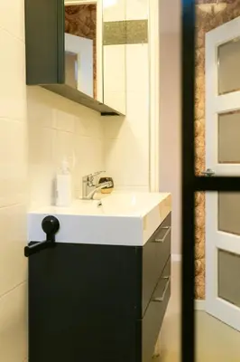 a bathroom with a sink and a mirror at Nice bright studio near the forest and Amsterdam in Baarn