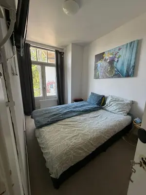 a bedroom with a bed and a window at Near Centrum in Amsterdam