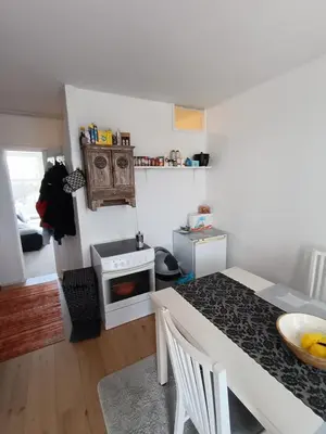 a kitchen with a table and a stove in a room at Near Centrum in Amsterdam