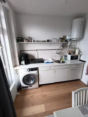 a small kitchen with a washing machine and a sink at Near Centrum in Amsterdam