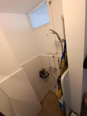 a small bathroom with a toilet and a window at Near Centrum in Amsterdam