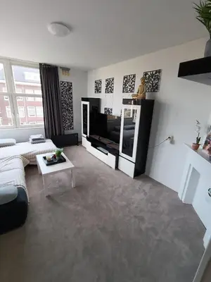 a living room with a couch and a tv at Near Centrum in Amsterdam