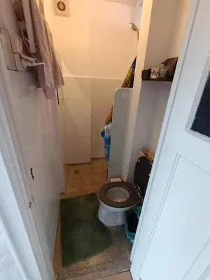 a bathroom with a toilet with a brown seat at Near Centrum in Amsterdam