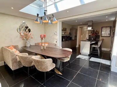 a kitchen and dining room with a wooden table and chairs at Vakantiewoning Casa Bergen Home in Bergen