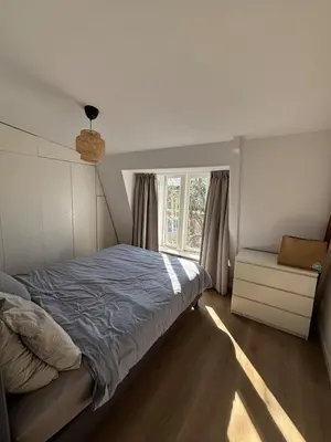 a bedroom with a bed and a window at Cozy Home in The Oude Pijp in Amsterdam