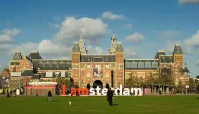 a large building with a sign in front of it at Cozy Home in The Oude Pijp in Amsterdam