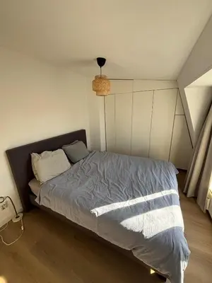 a bedroom with a bed with a blue comforter at Cozy Home in The Oude Pijp in Amsterdam