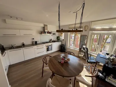 a kitchen and dining room with a table and chairs at Cozy Home in The Oude Pijp in Amsterdam