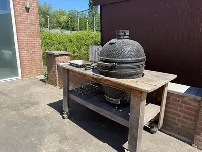 a grill on a wooden table with a pot on it at La Casa Goudacito in Gouda