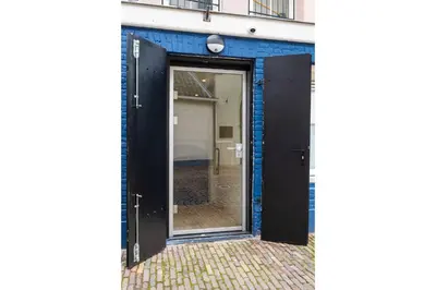 an open door on the side of a building at Unique underground hotel in Utrecht city center in Utrecht