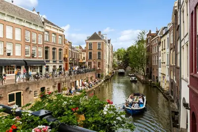 a group of people riding a boat down a canal at Unique underground hotel in Utrecht city center in Utrecht
