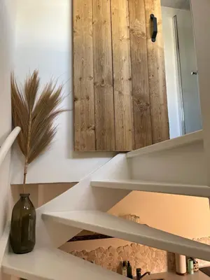 a bathroom with a mirror and a vase on a shelf at BeachHouse ibiza 19A in Noordwijk aan Zee