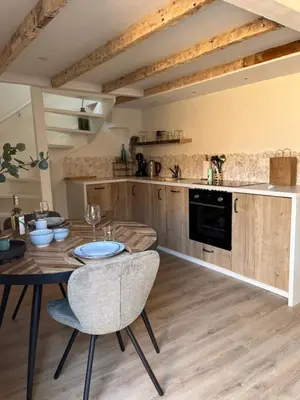 a kitchen with a table and chairs in a room at BeachHouse ibiza 19A in Noordwijk aan Zee