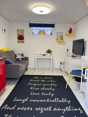 a living room with a couch and a rug at Zomerhuisje Maranatha in Noordwijk aan Zee