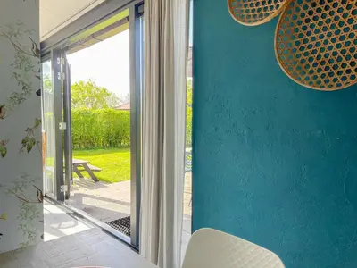 a room with a sliding glass door to a patio at The Kingfisher near beach and dunes Hargen and Schoorl in Dirkshorn