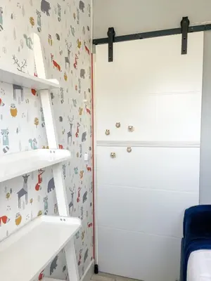 a childs bedroom with white shelves and a closet at The Kingfisher near beach and dunes Hargen and Schoorl in Dirkshorn