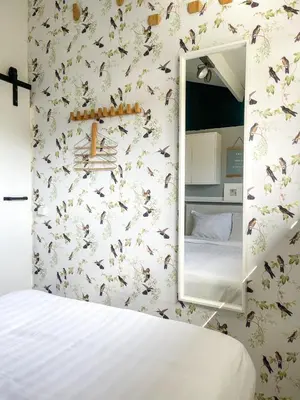a bedroom with a mirror and a bed at The Kingfisher near beach and dunes Hargen and Schoorl in Dirkshorn