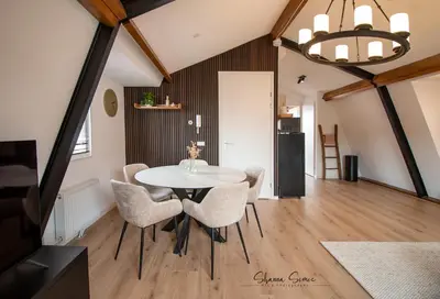 a dining room with a white table and chairs at ApartHotel De Koning by Urban Home Stay in Alkmaar