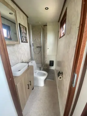 a bathroom with a toilet and a sink at Geniet van de rust en de ruimte in Bodegraven