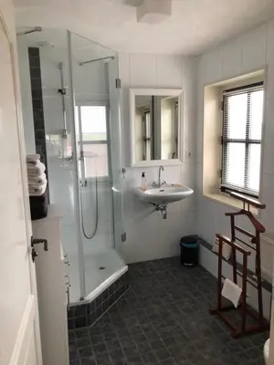 a bathroom with a shower and a sink and a shower at kleinrosenbrand in Burgerbrug