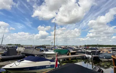 a bunch of boats are docked at a dock at Woonboot De Karekiet in Loosdrecht