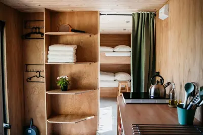 a room with a closet with a desk and towels at SRV wagen De Geus in Oud-Ade
