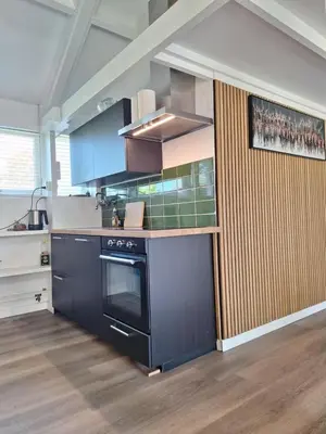 a kitchen with a black stove top oven at Rekerlanden 32 in Schoorldam