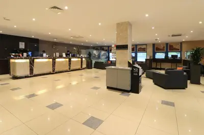a lobby with a waiting area and a restaurant at XO Hotels Blue Square in Amsterdam