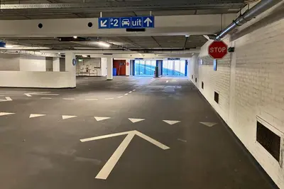an empty parking garage with a stop sign on the floor at XO Hotels Blue Square in Amsterdam