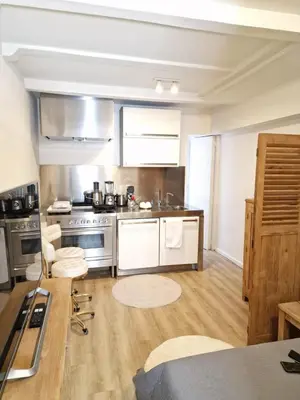 a kitchen with stainless steel appliances and wooden floors at New Apartment in the Heart of Amsterdam in Amsterdam
