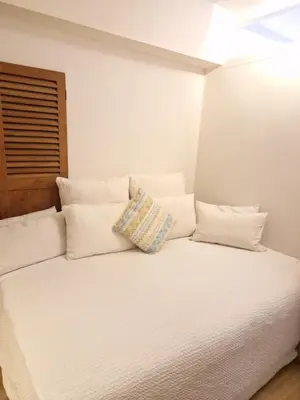 a white bed with white pillows on top of it at New Apartment in the Heart of Amsterdam in Amsterdam