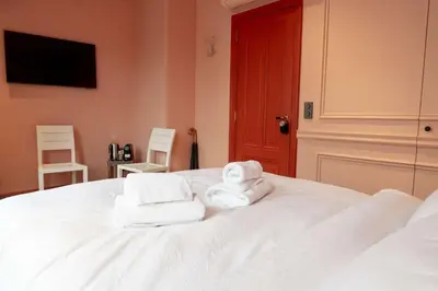 a bedroom with a bed with towels on it at Suite Palette in Amsterdam