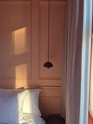a bedroom with a white bed and a cabinet at Suite Palette in Amsterdam
