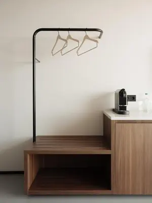 a shelf with hangers on a white wall at Hotel V Oosterpark in Amsterdam