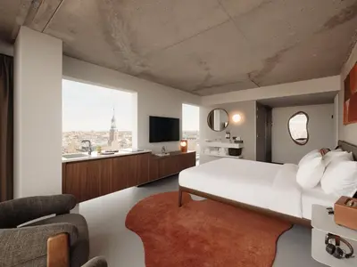 a bedroom with a white bed and a large window at Hotel V Oosterpark in Amsterdam