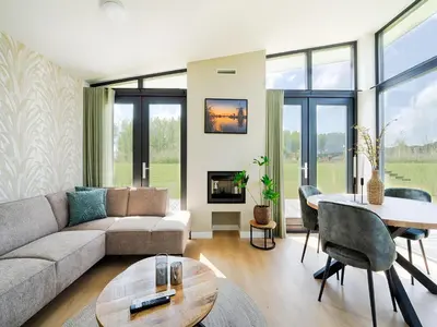 a living room with a couch and a table at Holiday Home in Oud Ade near Kaag Lakes in Oud-Ade