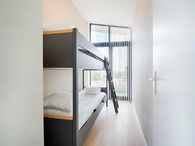a bedroom with a bunk bed and a window at Holiday Home in Oud Ade near Kaag Lakes in Oud-Ade
