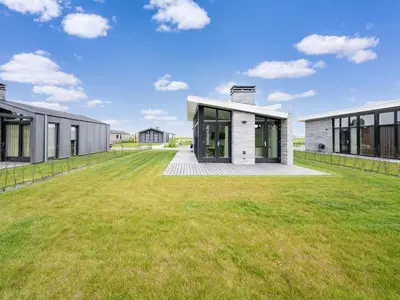 a house with a large lawn in front of it at Holiday Home in Oud Ade near Kaag Lakes in Oud-Ade