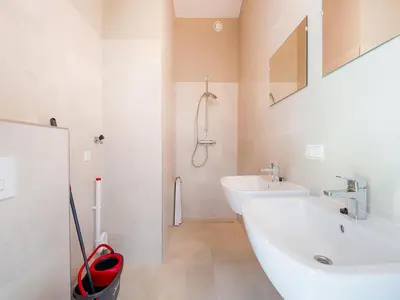 a white bathroom with a sink and a shower at Holiday Home near Kaag Lakes and Leiden Canals in Oud-Ade