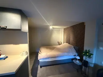 a bedroom with a bed in a small room at Katwijks geluk in Katwijk aan Zee