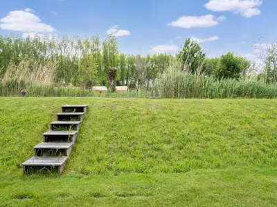 a set of stairs in a field of grass at Holiday Home in Oud Ade near Kaag Lakes in Oud-Ade