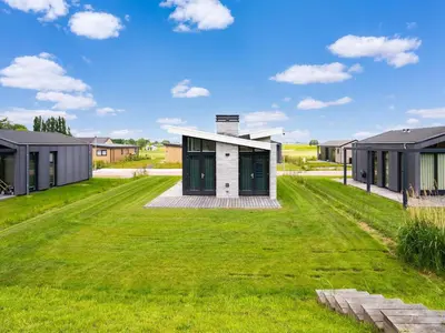 a modern house with a green lawn at Holiday Home in Oud Ade near Kaag Lakes in Oud-Ade