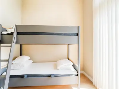 a bunk bed with white sheets and pillows on it at Holiday Home Oud Ade near Kaag Lakes in Oud-Ade