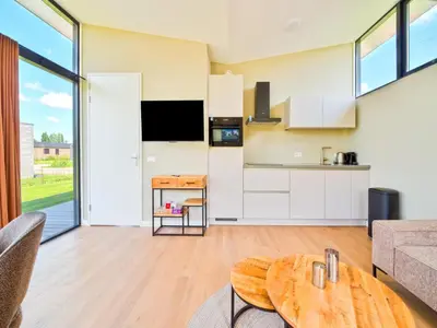 a kitchen and living room with a table at Holiday Home in Oud Ade near Kaag Lakes in Oud-Ade