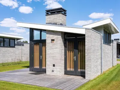 a house with a deck and a chimney at Holiday Home in Oud Ade near Kaag Lakes in Oud-Ade