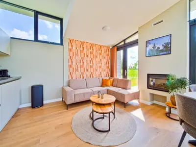 a living room with a couch and a table at Holiday Home in Oud Ade near Kaag Lakes in Oud-Ade