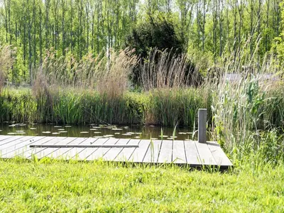 a dock in the middle of a body of water at Holiday Home in Oud Ade near Kaag Lakes in Oud-Ade
