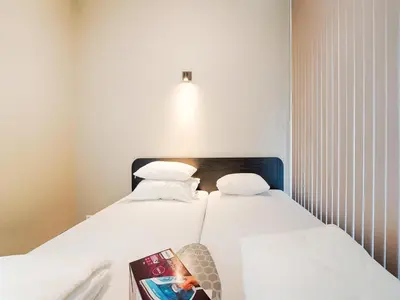 two beds in a room with a book on a table at Holiday Home in Oud Ade near Kaag Lakes in Oud-Ade