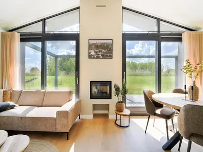 a living room with a couch and a table at Holiday Home in Oud Ade near Kaag Lakes in Oud-Ade