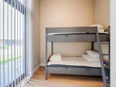a bunk bed in a room with a window at Holiday Home in Oud Ade near Kaag Lakes in Oud-Ade